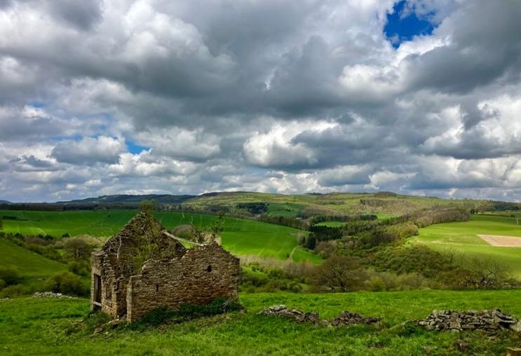 A ruined stone barn above the valley